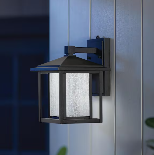 Home Decorators Collection- Mauvo Canyon 11 in. Black Dusk to Dawn Small LED Outdoor Wall Light Fixture Porch Sconce with Seeded Glass
