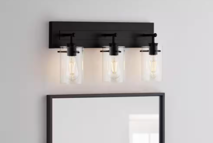 Hampthttps://www.homedepot.com/p/Hampton-Bay-Regan-21-in-3-Light-Matte-Black-Bathroom-Vanity-Light-with-Clear-Glass-Shades-DSHD19574V2/316719920on Bay Regan 21 in. 3-Light Matte Black Bathroom Vanity Light with Clear Glass Shades DSHD19574V2